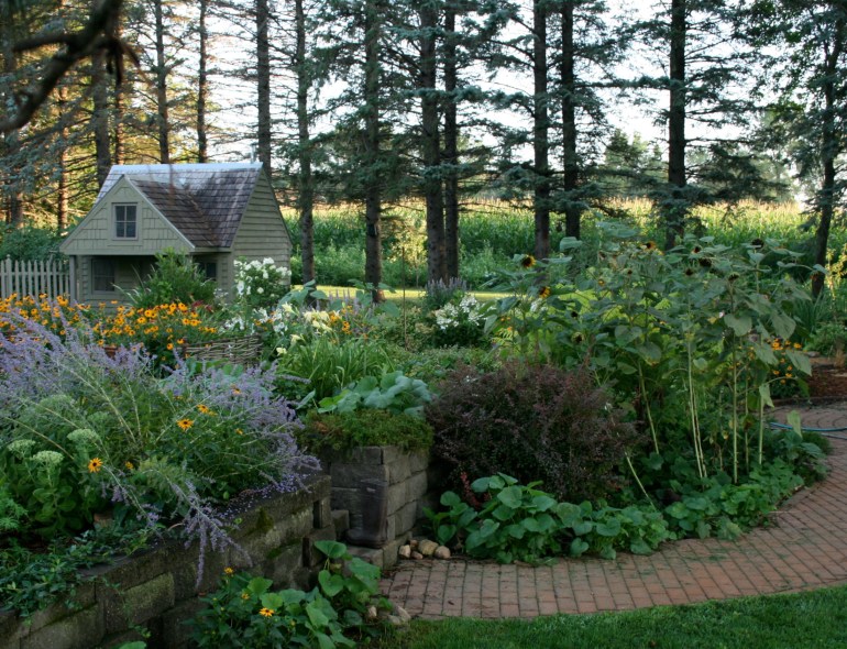 Rabbit Run Cottage has grown up along with Lucy.Her colors are more muted for the garden, and the play kitchen was retired.  A pile of pillows, quilts and books are in the loft.  She is very gracious in sharing her little house with me.  
